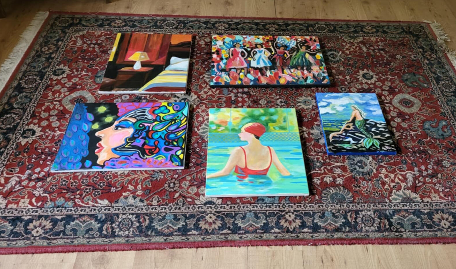 photo by Lucie Walker photof of a ceramic crow, a ceramic plate of gemstones, a lit salt lamp, a fern, some hanging ornaments in a window